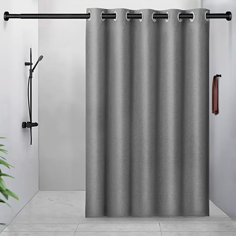 Minimalist grey polyester shower curtain hanging over bathtub