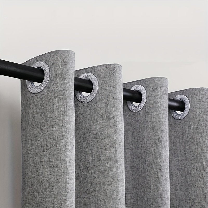 Close-up of large silvery rings on linen-look shower curtain