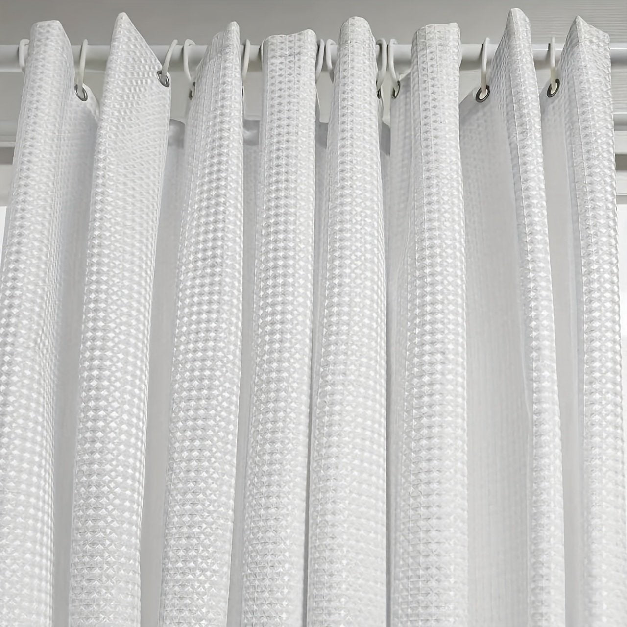 Close-up of laminated waffle texture on jacquard shower curtain