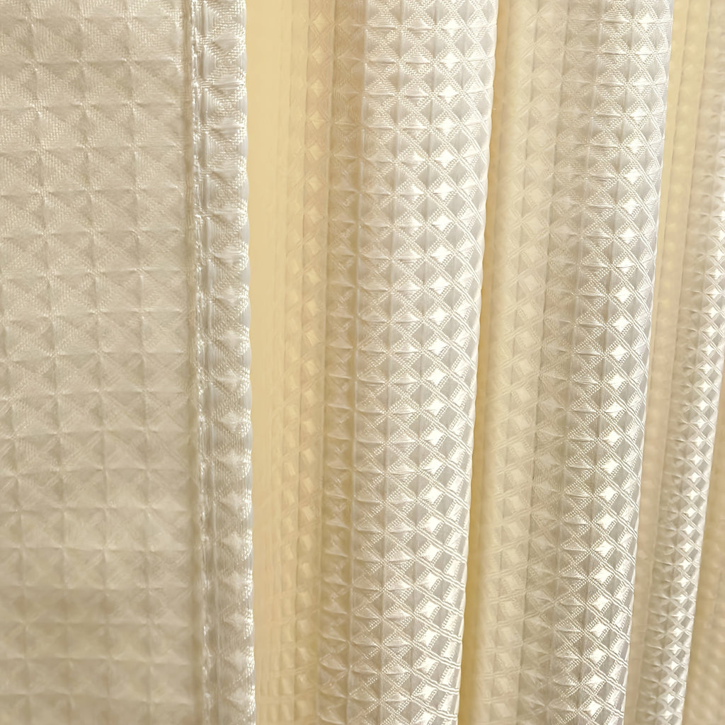 Light grey waffle weave shower curtain in neutral bathroom