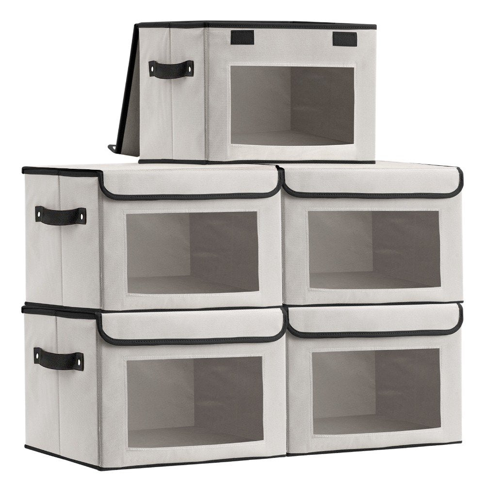 Foldable storage cube holding folded clothes with lid open