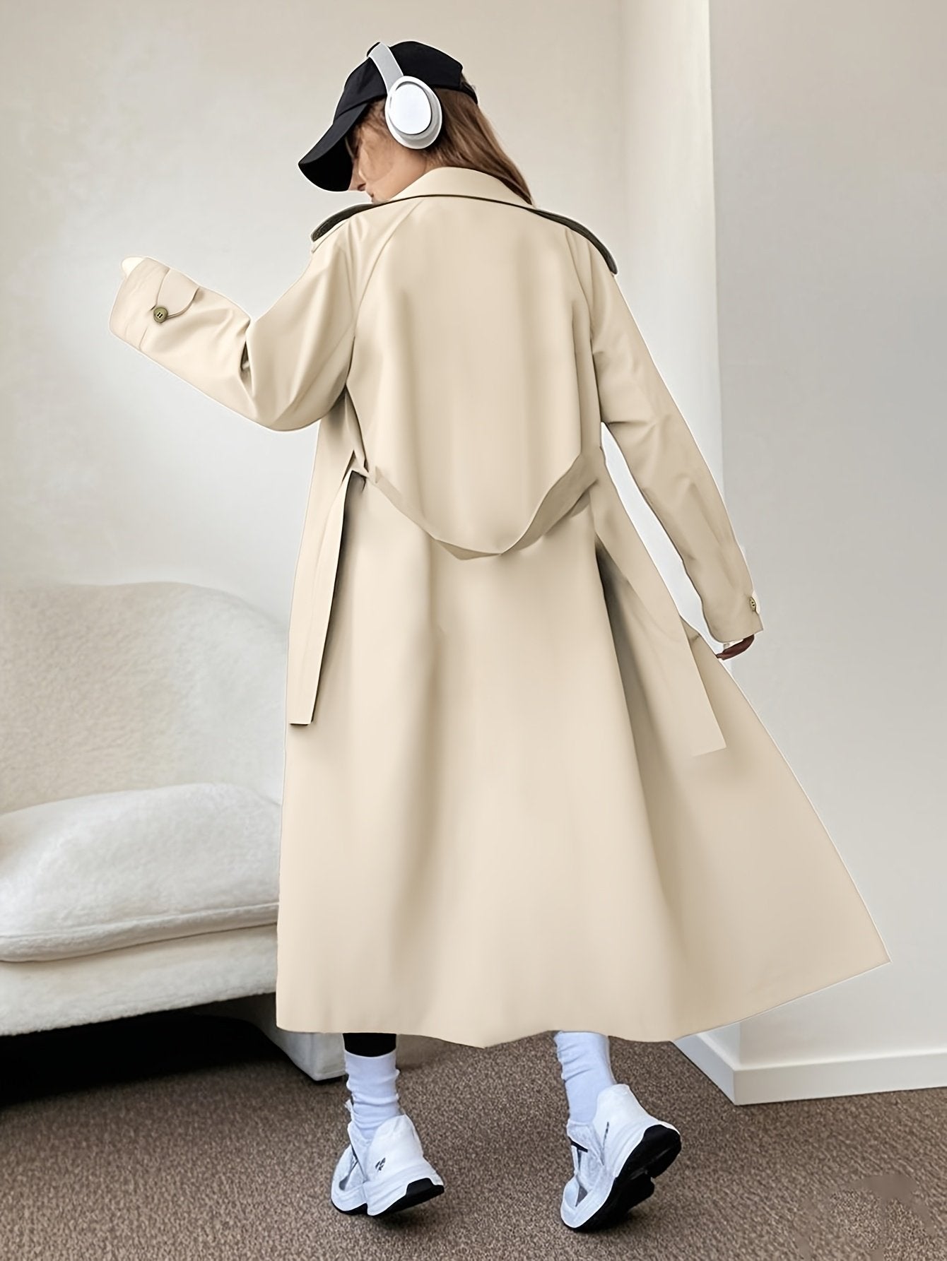 Side profile of the knee-length women's trench coat showing the straight cut