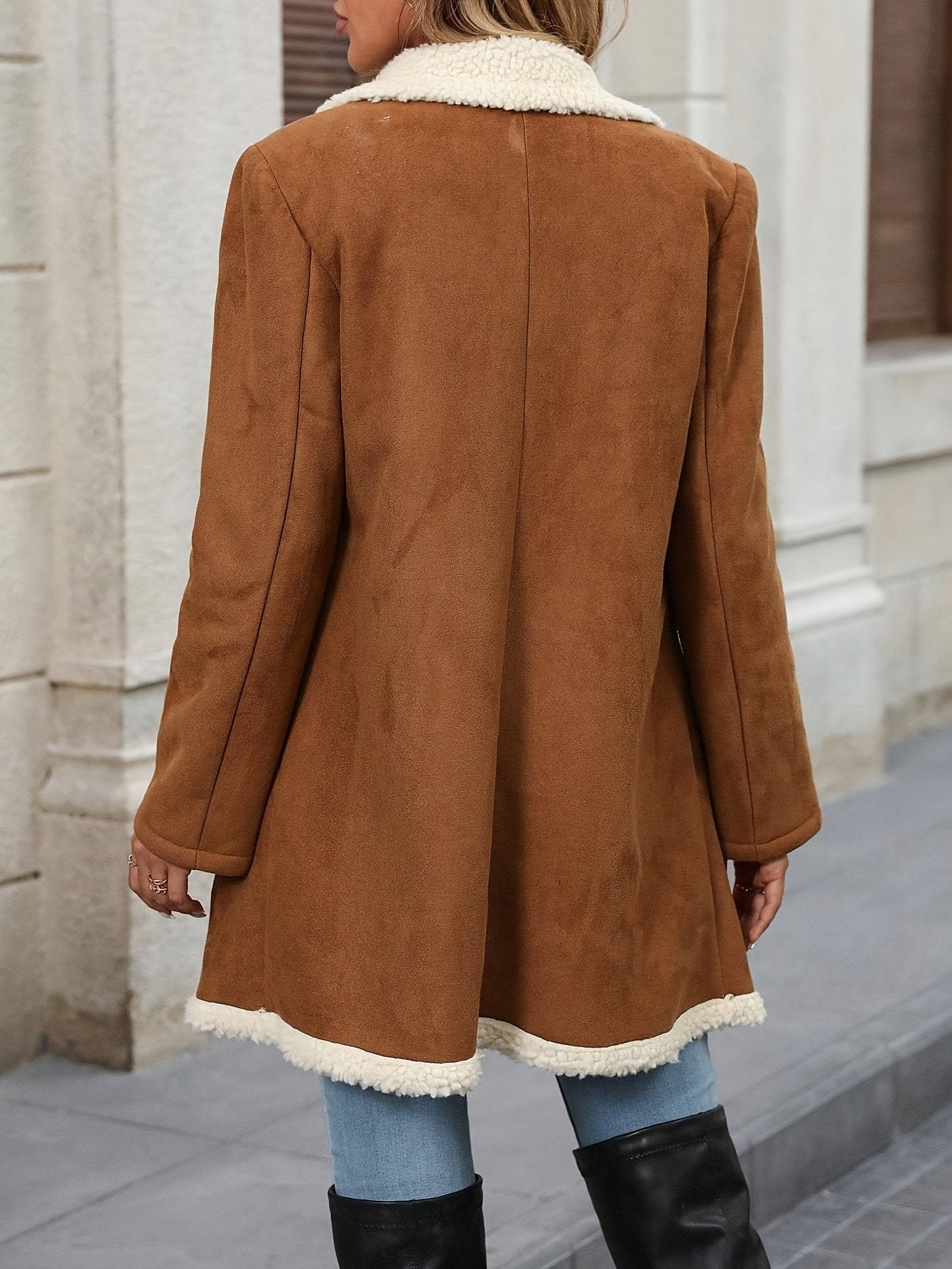 Side view of the long lamb effect coat showing the below-hip length