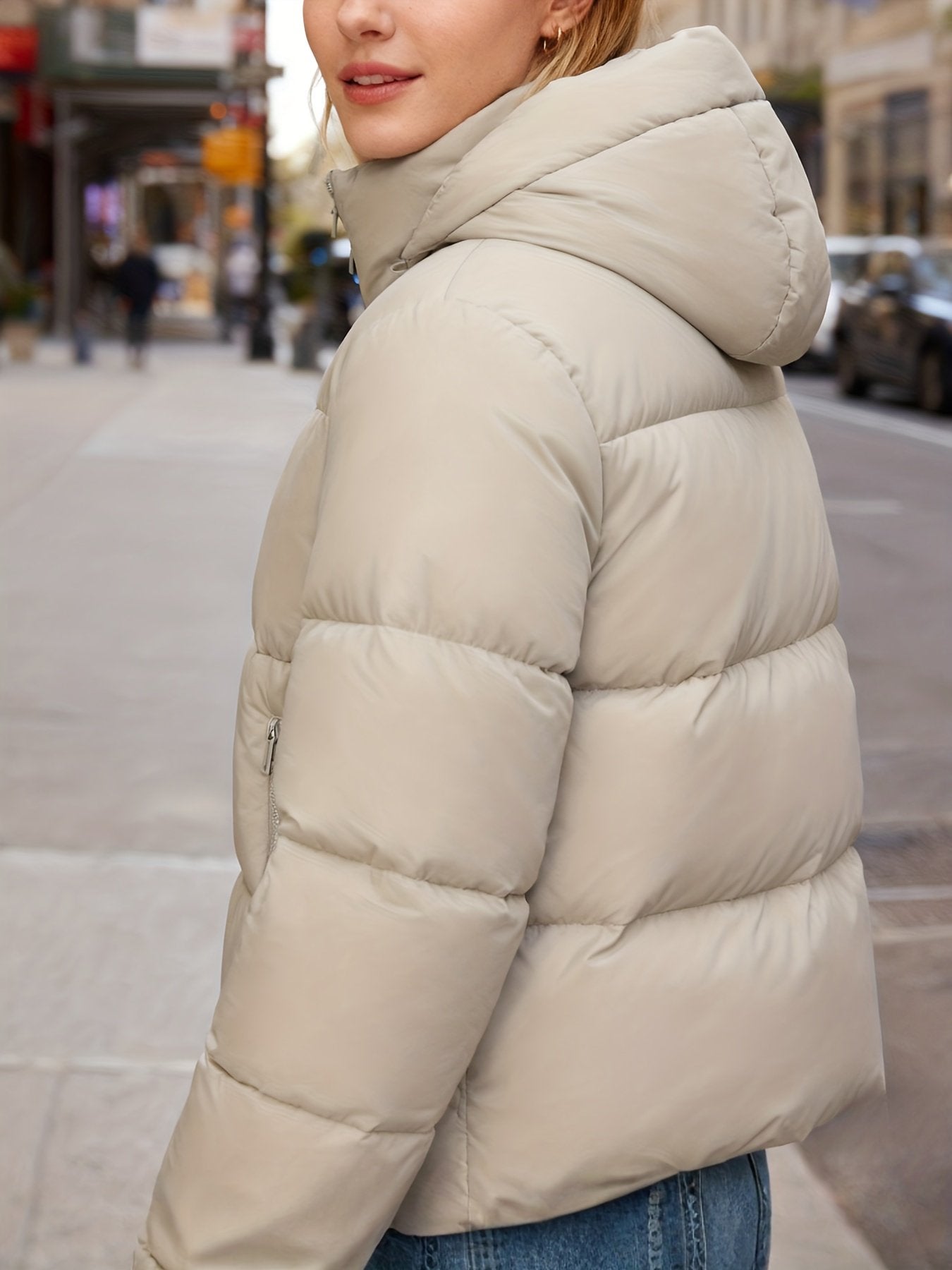 Close-up of the detachable hood zip on the women's puffer jacket