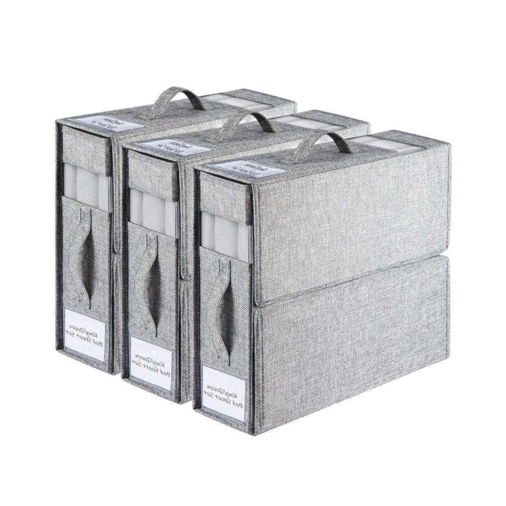 Linen wardrobe storage box holding folded bed sheets and towels