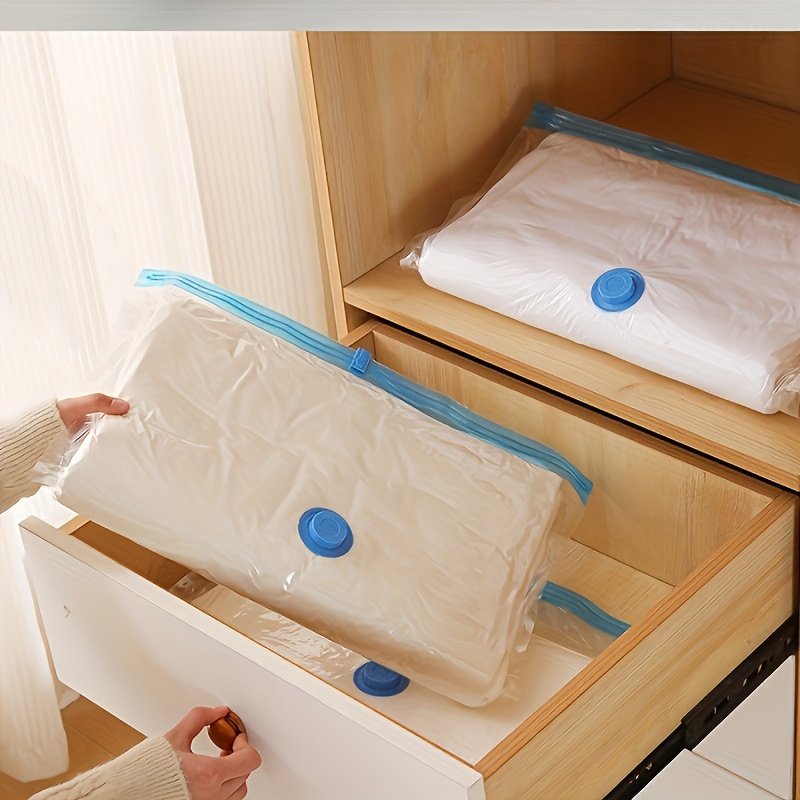 Clothes shrinking in space-saving vacuum bag for small flat storage