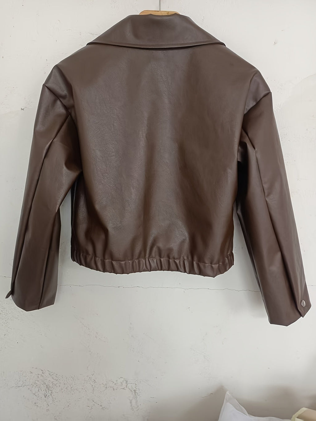 Back view of the women's black faux leather jacket