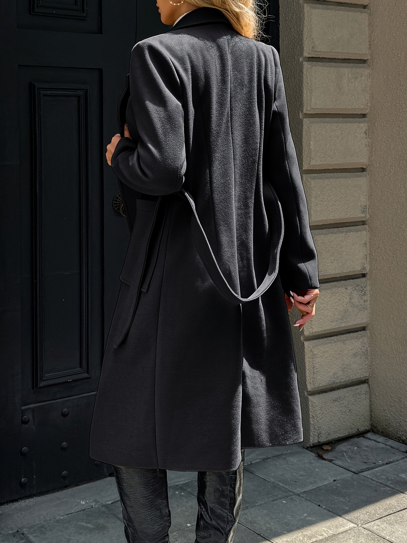 Back view of the women's long belted camel winter coat