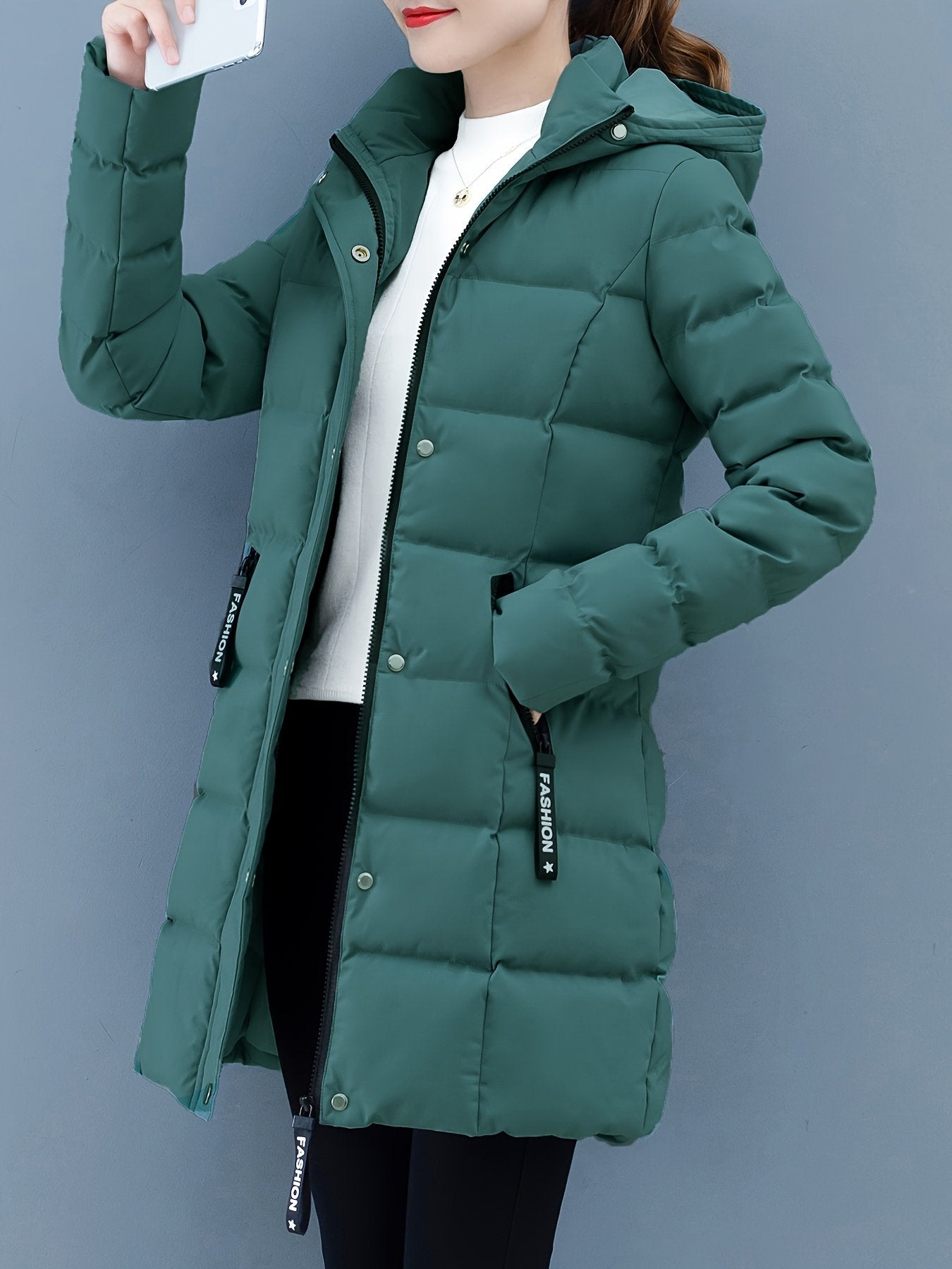 Blue mid-length puffer jacket for women worn with the hood up