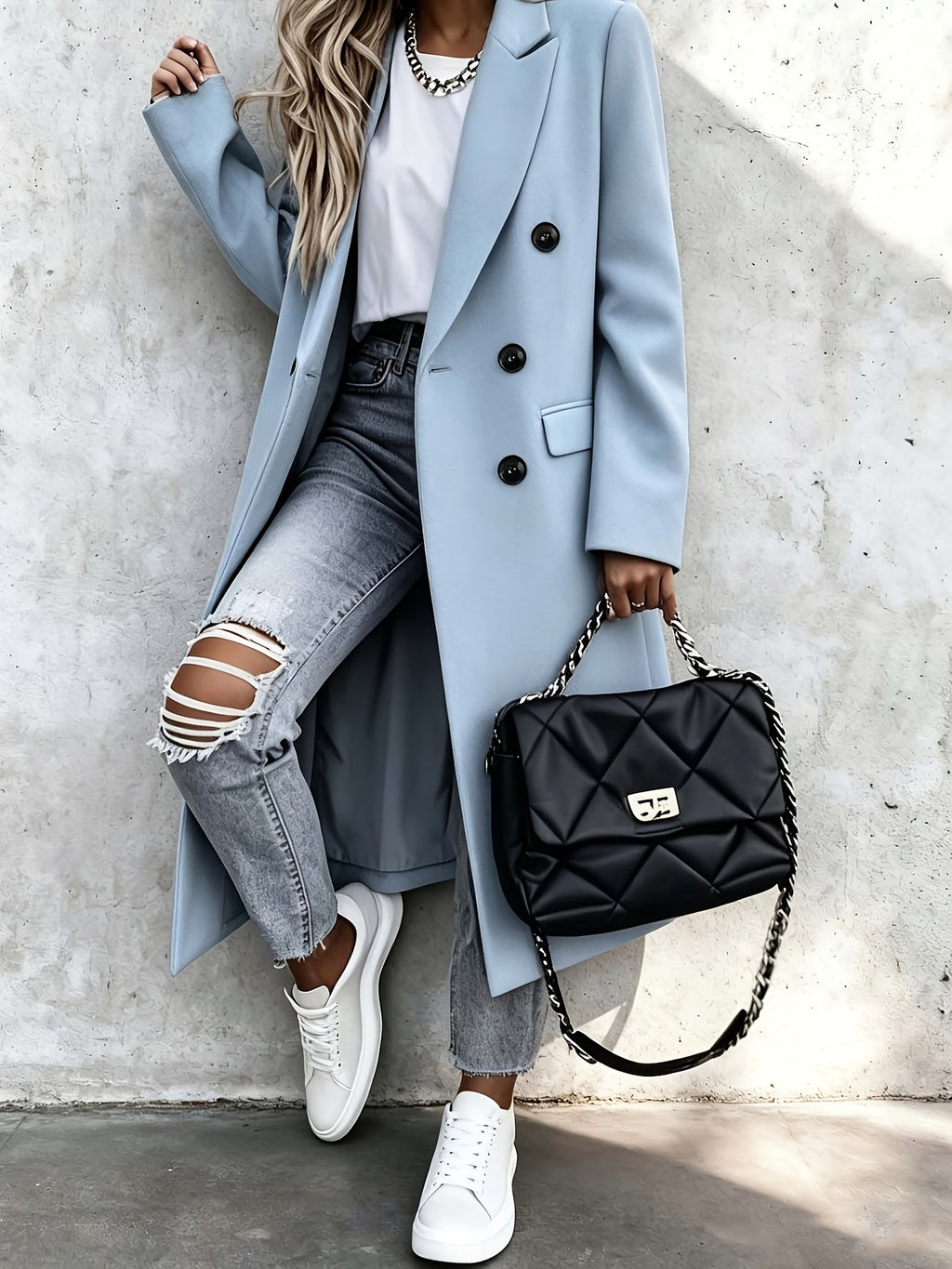 Side view showing the over-the-knee hemline of the women's grey coat
