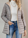 Zip and pocket detail on the women's hooded padded coat