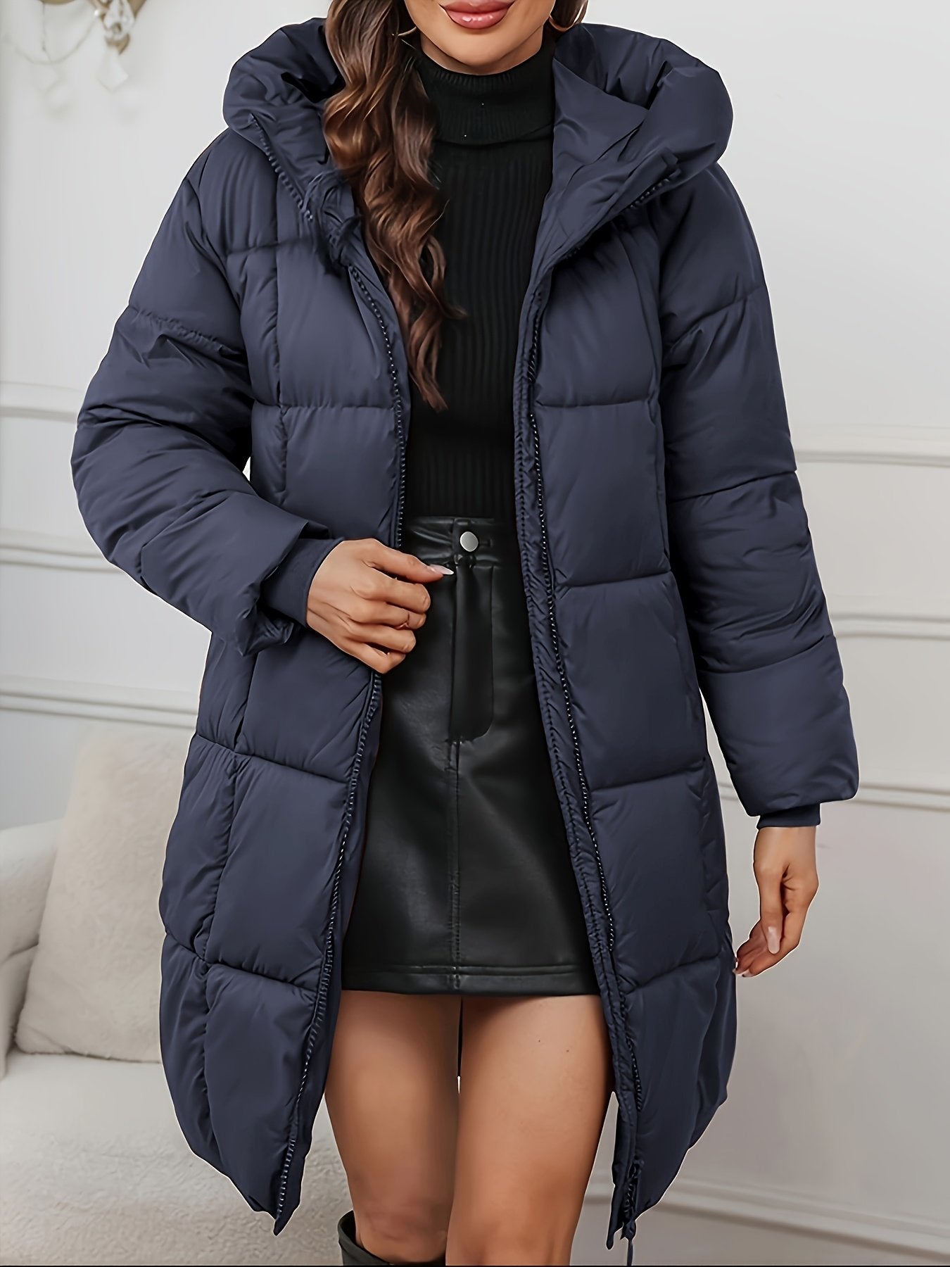 Side view of the long cut on the women's hooded puffer coat