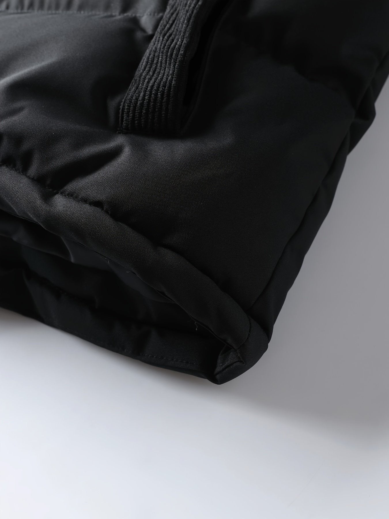 Side view of men's thick spliced winter coat with zip-up front