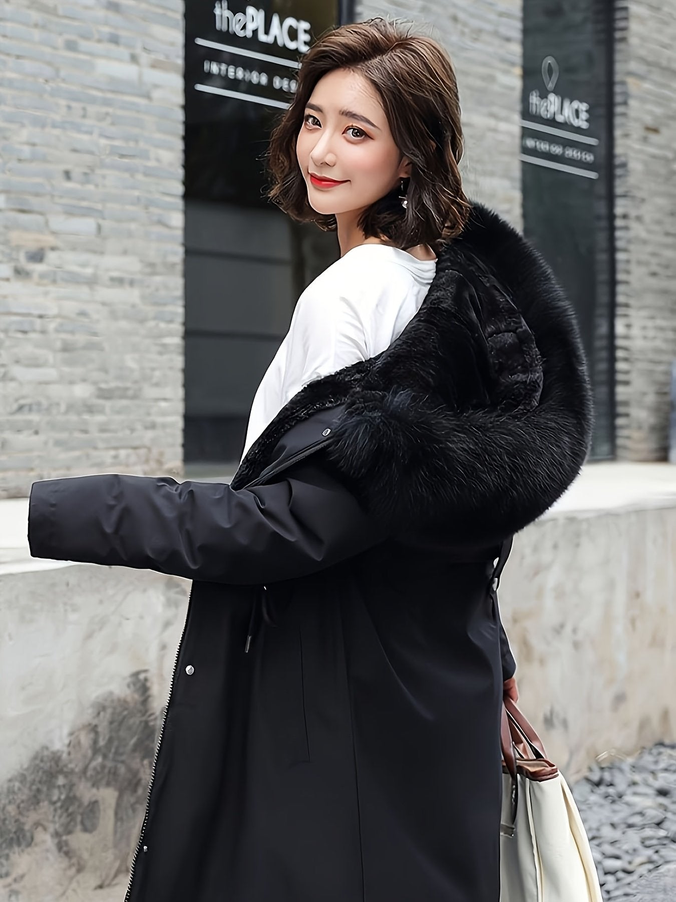 Back view of the women's black fleece-lined winter parka