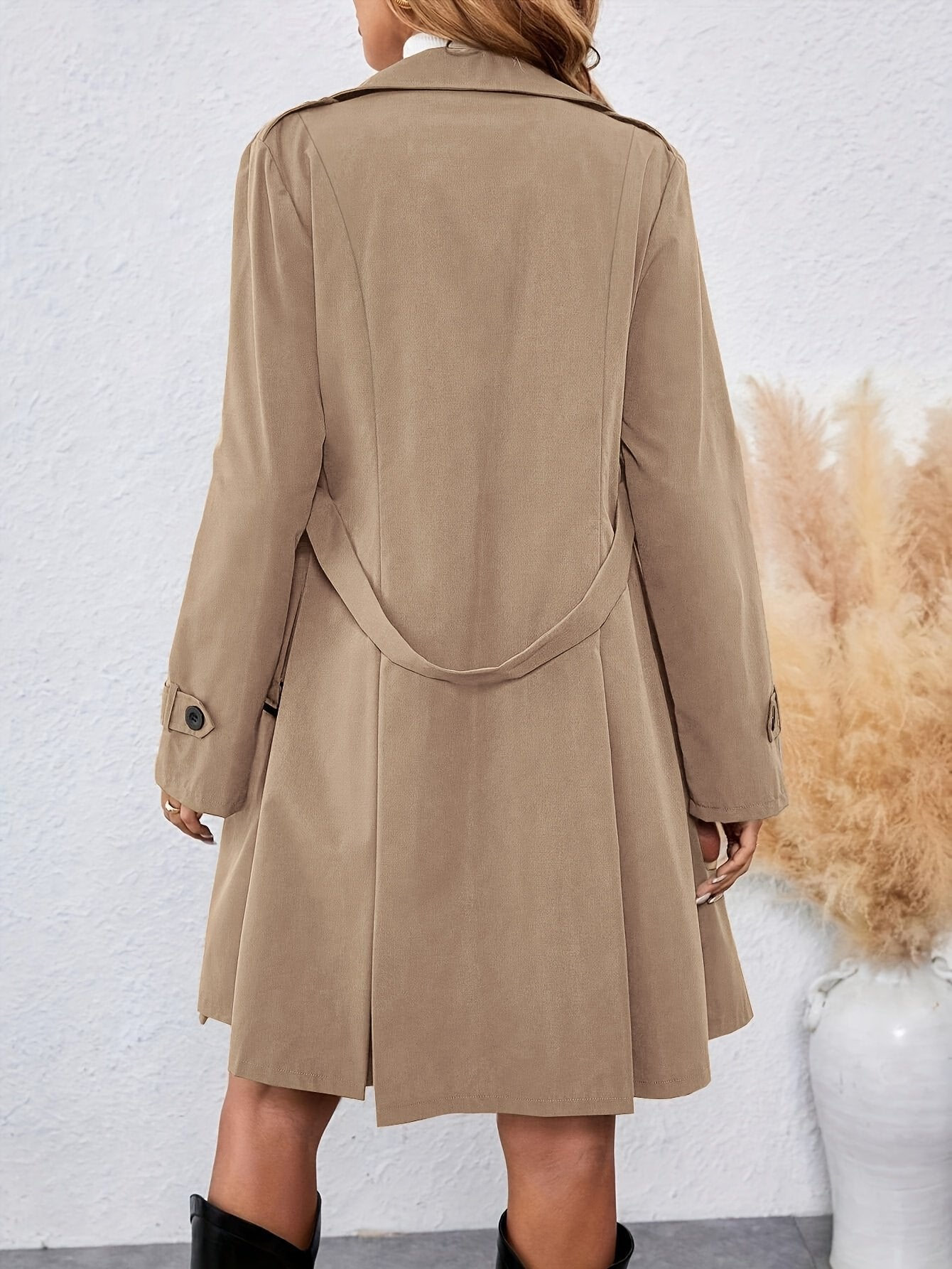 Side view of the long women's trench coat showing the below-knee hemline